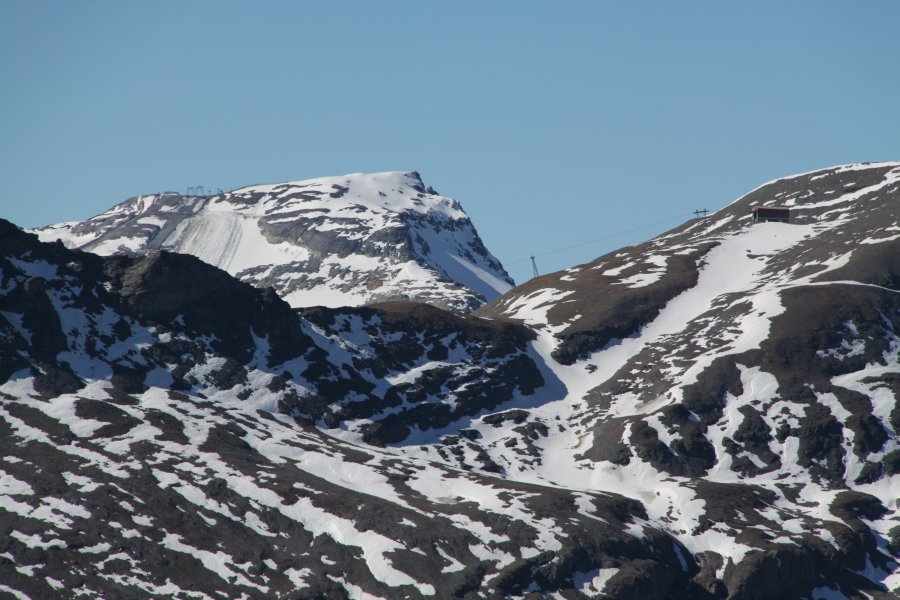 Zoom ins Hauptgebiet der Weissen Arena: Vorne rechts der Bildmitte die Bergstation der Sesselbahn La Siala, links der Bildmitte im Hintergrund die letzten beiden Stützen der Vorab-Gletscherskilifte, Oktober 2010